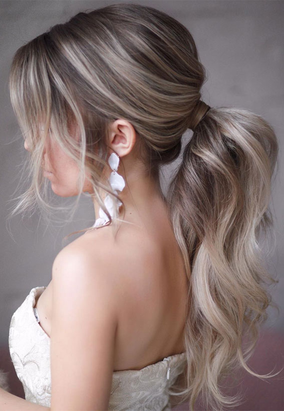Side parted bridal ponytail with braid and flowers
