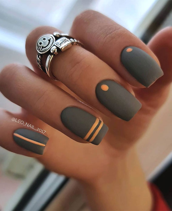 Closeup woman hand with dark gray and black nail polish on fingernails. Nail  manicure with gel