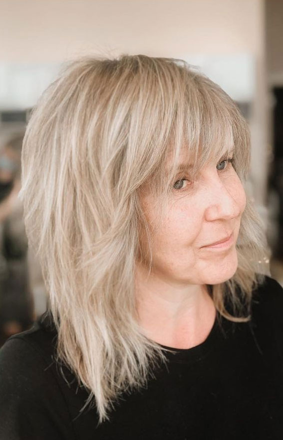 Image of Layered shag haircut with bangs for women over 50