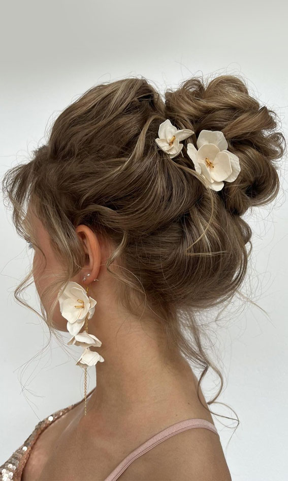 35 Enchanting Hairstyles for a Fairytale Wedding : Textured High Bun with White Floral Hair Pins