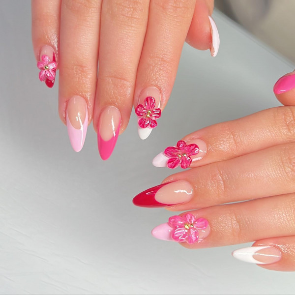 pink french tip nails with pink 3d flower accents