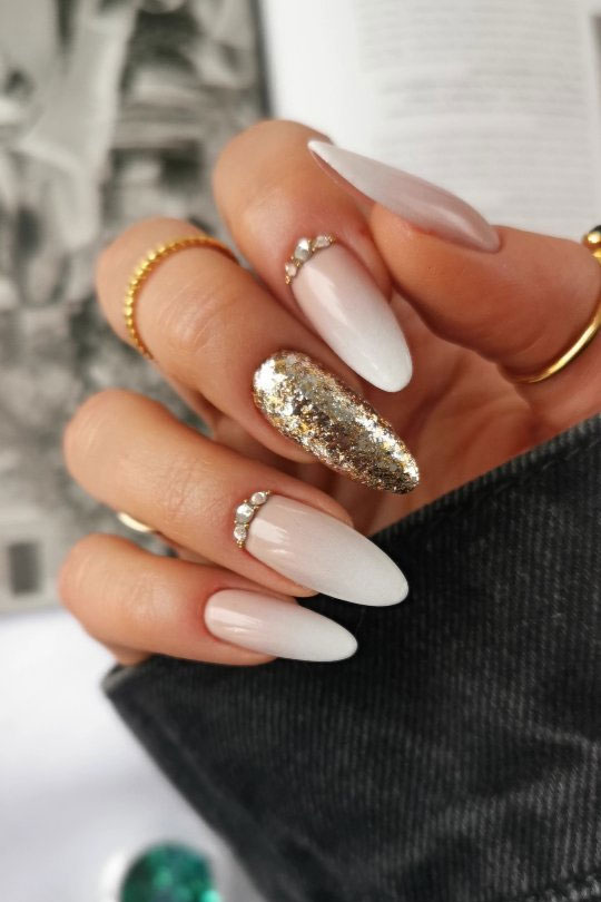 Nude Ombré Almond Nails with Glitter Gold and Rhinestone Embellishments