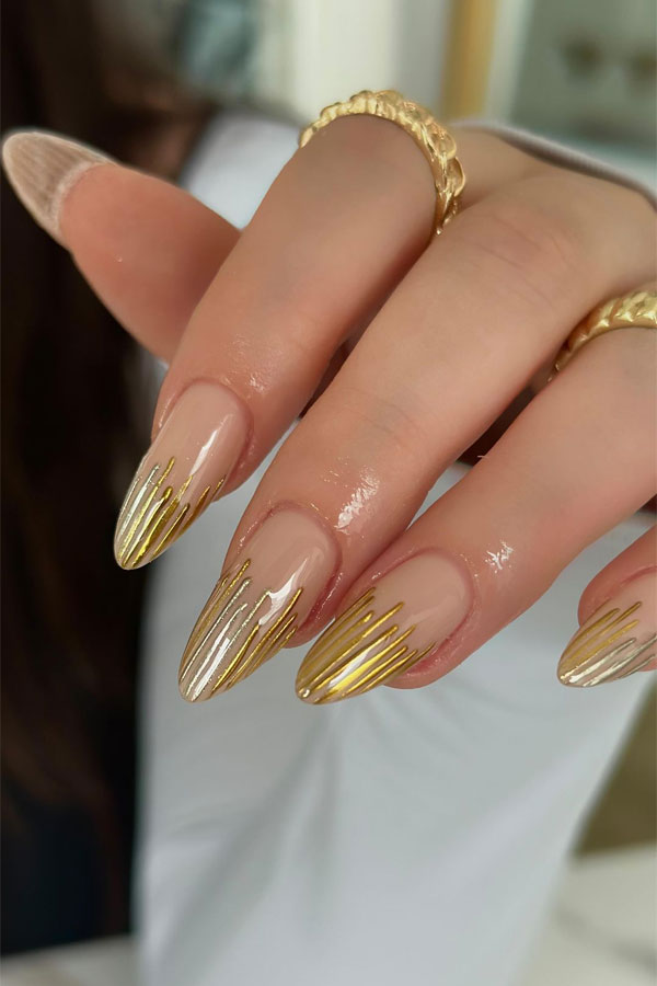 Modern Elegant Nude Almond Nails with Gold Drip Accents