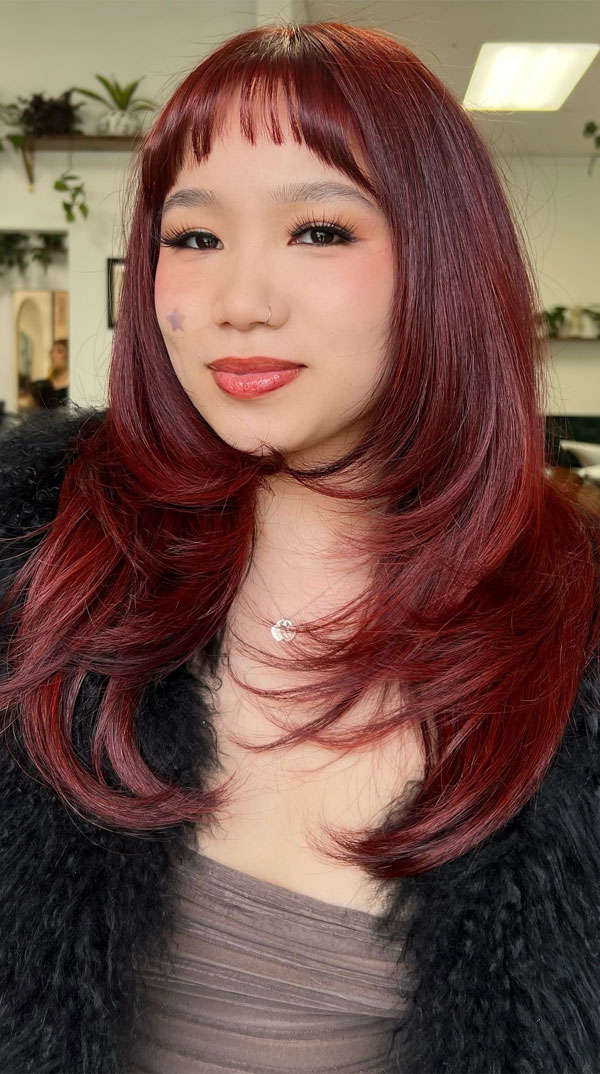 27 Long Layered Haircuts for Round Faces : Vibrant Red Layers with Baby Bangs