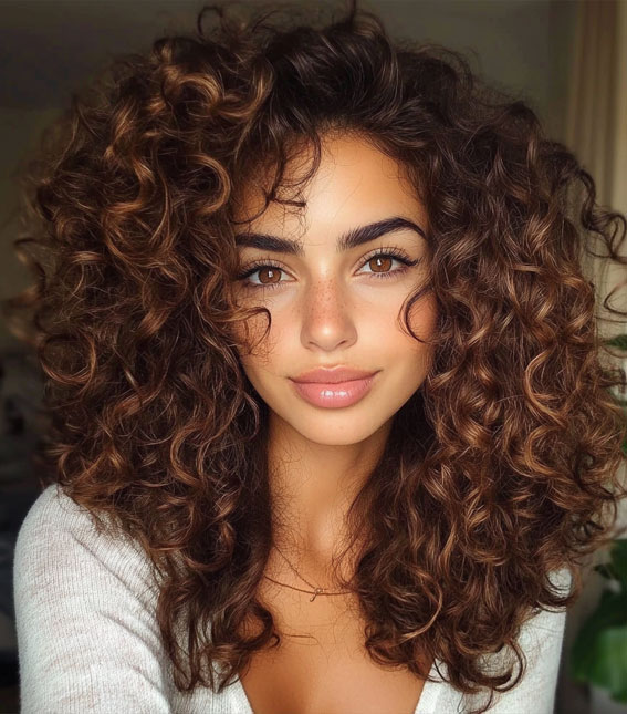 Chestnut Curls with a Slightly Tousled Finish, Shoulder length curly hair with layers, low maintenance Shoulder length curly hair with layers, medium length curly hair with layers, Shoulder length curly hair with layers and bangs, natural curly haircut, natural curly hair with layers