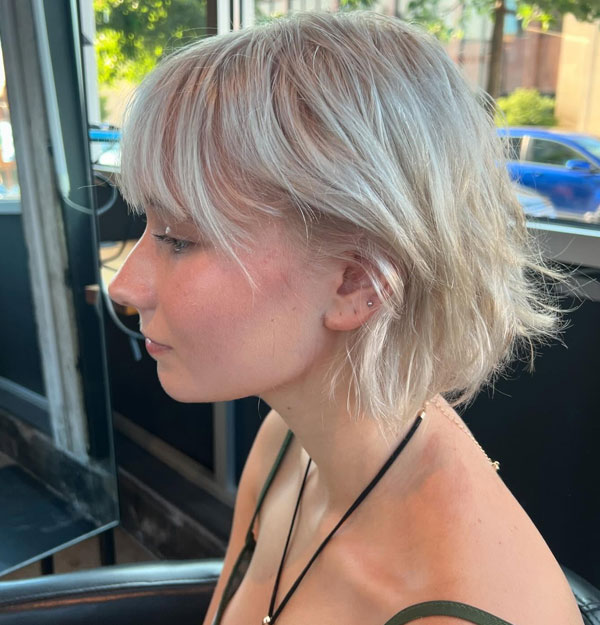 23 French Hairstyles for Effortless Chic Style : Tousled Platinum Blonde Bob with Soft Bangs