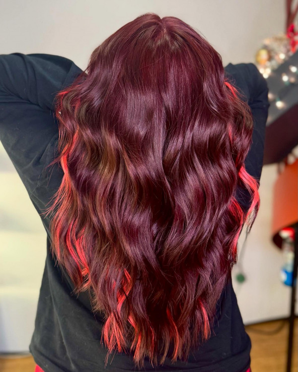 41 Red Hair Colours You’ll Adore: Deep Burgundy Waves with Fiery Peekaboo Highlights