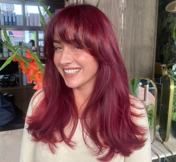 30 Cherry Hair Colour Ideas : Playful Cranberry Layers with Bangs