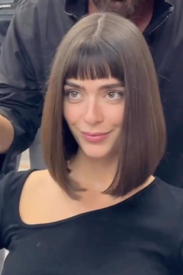 30 Medium-Length Haircuts for Different Face Shapes : Sleek Blunt Bob with Bangs