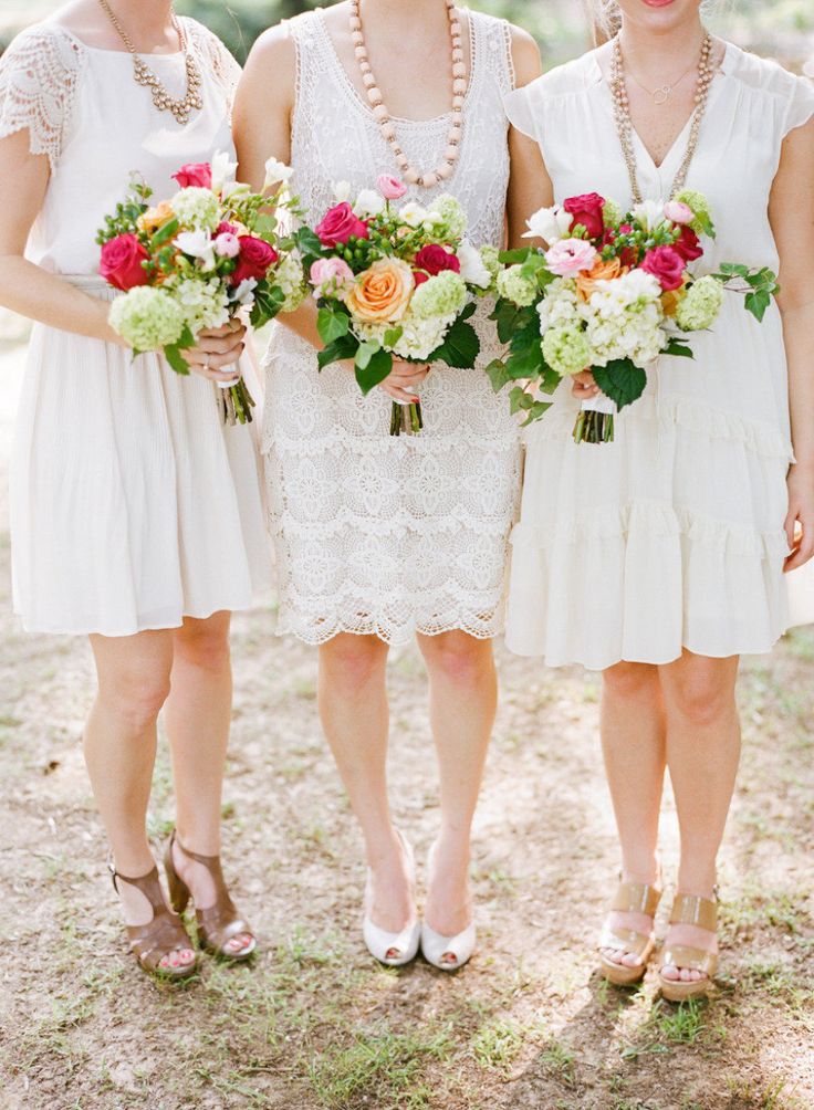 Mismatched pretty white bridesmaid dresses with 1920s edge, with lace, ruffles and worn with beads