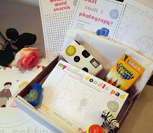 wedding activity box for kids - disposable camera, "picture search", wedding word search, handmade wedding coloring book/crayons, finger puppets, stuffed animal, treats... CUte packaging ideas too.