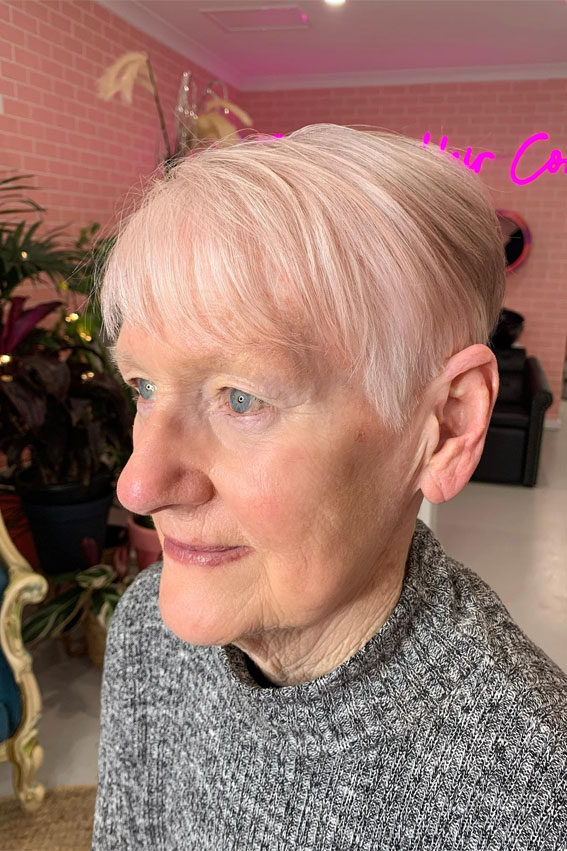 short haircut, haircut for over 60, Pink Hued Sleek Pixie Haircut with wispy bangs