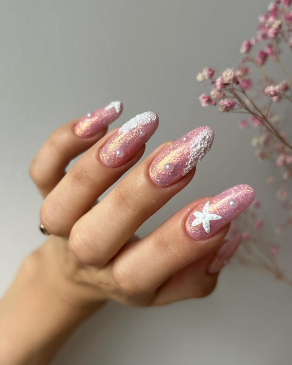 shimmery pink nails with starfish accent nails